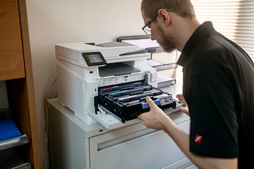 Cameron servicing a color laser printer